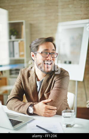 Asian businessman sitting at workplace in office Stock Photo