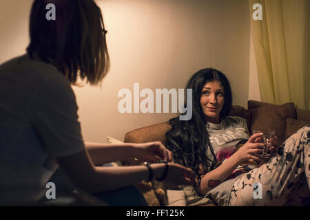 Caucasian women talking in living room Stock Photo