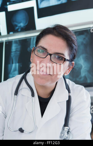 Hispanic doctor smiling in hospital Stock Photo