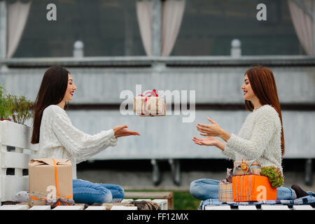 Girls throws gifts to each other Stock Photo