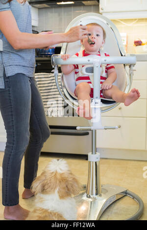 Mixed race mother feeding baby outdoors Stock Photo