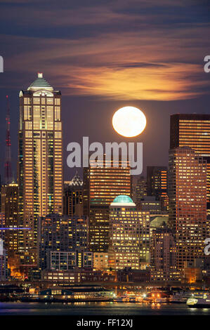 Moon and high rise buildings over Seattle waterfront, Washington, United States Stock Photo