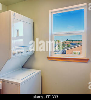 Washer and dryer with window in laundry room Stock Photo