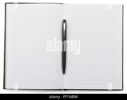 Open notebook with a pen lying in the middle Stock Photo