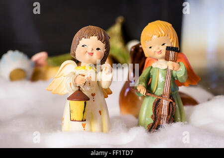 Christmas decorations featuring small angels making music in the snow in an English home in Uk Stock Photo