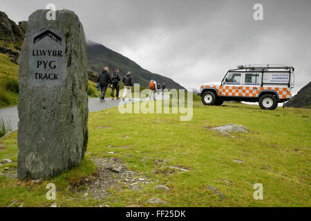 Mountain rescue ambulance waiting at the start of the Pyg track leading to the summit of Mount Snowdon, Wales on a rainy day. Stock Photo