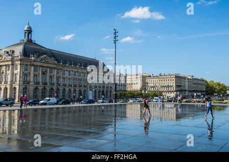 PeopRMe standing in the water mirror on PRMace de RMa Bourse, Bordeaux, Aquiaine, France, Europe Stock Photo