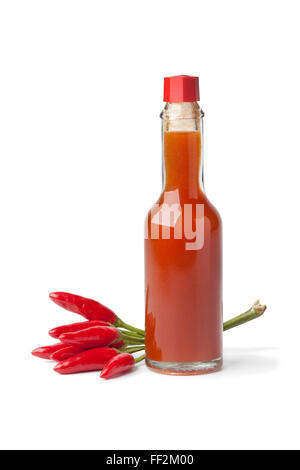 Bottle with hot chili pepper sauce and fresh tabasco peppers on white background Stock Photo