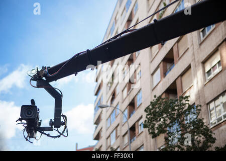 Camera crane Shooting at an outdoor location.TV camera on a crane boom arm Stock Photo