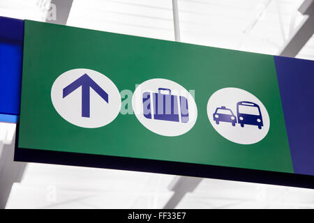 Picture of a directional airport sign with baggage claim and ground transportation symbols. Stock Photo