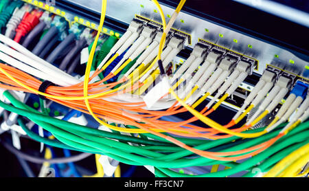 Active optical and ethernet switches installed in the rack. Color toning effects applied Stock Photo