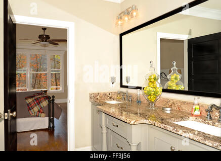 View of new modern bathroom with view into the master bedroom. Stock Photo