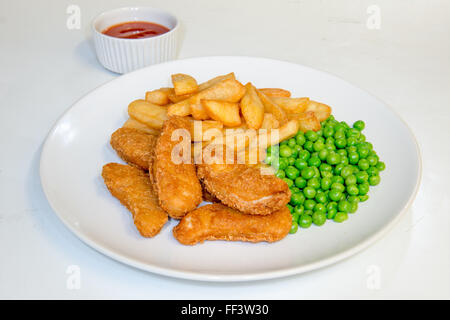 Chicken nuggets meal with chips, peas and tomato dipping sauce Stock Photo