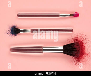 Makeup brushes with powder and gloss Stock Photo