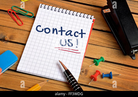 Call us word on notepad Stock Photo - Alamy