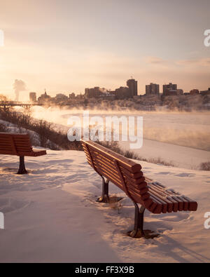 Steam rises from the South Saskatchewan River in Saskatoon, Saskatchewan, Canada, on a very cold winter day. Stock Photo