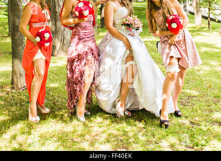 Row of bridesmaids with bouquets at wedding ceremony Stock Photo