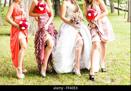 Row of bridesmaids with bouquets at wedding ceremony Stock Photo