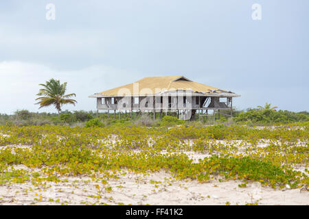 Derelict wooden building on stilts on a beach in south Barbuda, Antigua and Barbuda, West Indies Stock Photo