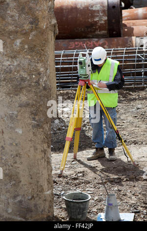 Installing Geothermal International’s ‘Energy Pile’ ground source heat pumps at a building in the City of London. A surveyor checks that the pile are in the correct place. Stock Photo