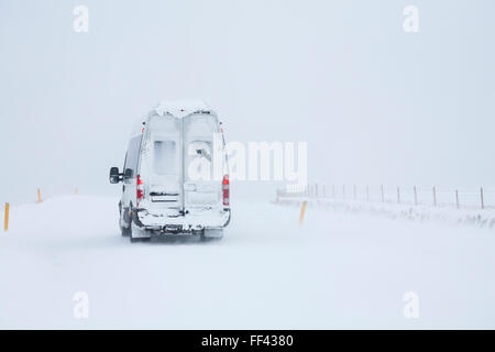 Van driving through whiteout snowy conditions in Iceland in January Stock Photo