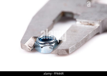 caliper and nut closeup isolated on white background Stock Photo