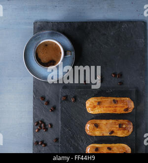 Coffe eclairs with cup of coffee Stock Photo