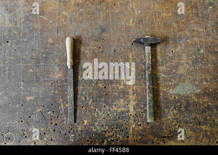 Old carpenters hammer and rasp on a vintage wooden background Stock Photo
