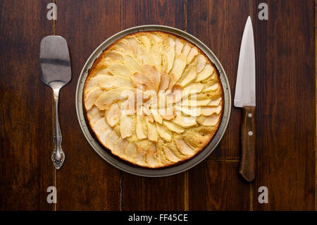 Home made apple pie over wooden background with cutlery Stock Photo