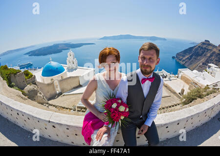 Young wedding couple walking on the island of Santorini, Greece Stock Photo