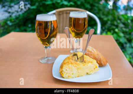 Spanish appetizer: pincho de tortilla and two glasses of beer in a terrace. Madrid, Spain. Stock Photo