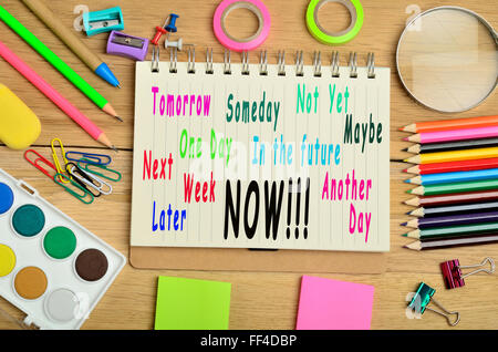 Tomorrow Someday Not Yet NOW written on notebook Stock Photo