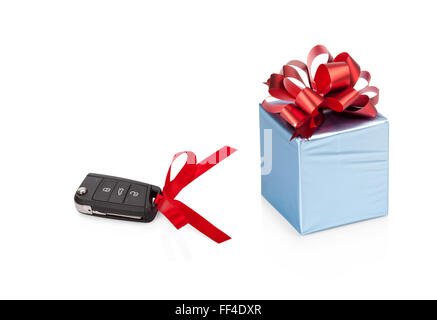 Gift concept: Car keys with blue gift box with red ribbon isolated on white Stock Photo