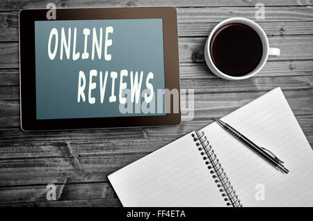 Online reviews words on digital tablet Stock Photo