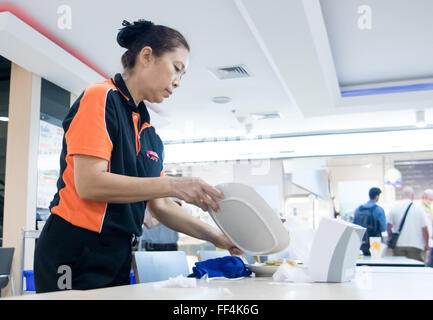 Woman Scraping Food Leftovers from dish Stock Photo