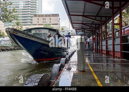 Public transport boat arriving at the pier on the canal Stock Photo