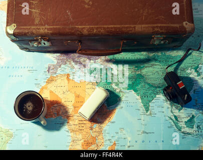 Travel planning concept with coffee cup and suitcase Stock Photo