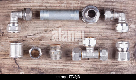 tools fittings plumbing on a woody background Stock Photo