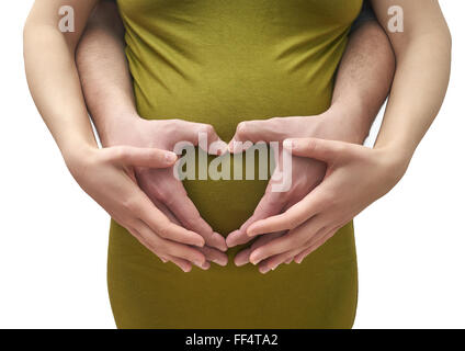 A couple making a heart shape on the pregnant belly with their hands. Stock Photo