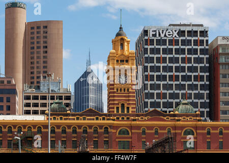 MELBOURNE - JAN 31 2016: Flinders street station clock tower and office high rise buildings in the background Stock Photo