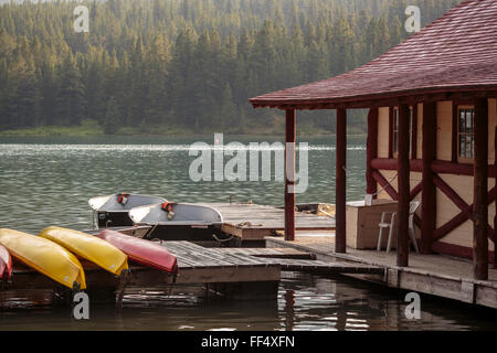 Evening light rims Jasper National Park's Maligne Lake and the historic Curly Phillips Boat House in Canadian Rocky Mountains. Stock Photo