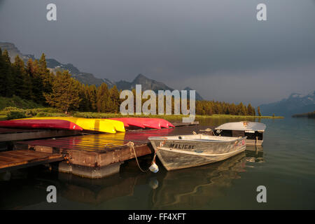 Evening light over Jasper National Park's Maligne Lake and boats available for rent at the historic Curly Phillips Boathouse.