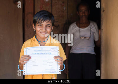 A young girl from the Dobhanda Nagar slum in Cuttack gets her birth certificates from the Urban Law centre run by the organisation CLAP. Committee for Legal Aid to Poor (CLAP) helps provide legal aid to the poorer communities in the Orissa district of India. Stock Photo