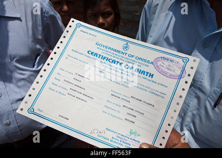 Children from the Dobhanda Nagar slum in Cuttack receive birth certificates from the Urban Law centre run by the organisation CLAP. Committee for Legal Aid to Poor (CLAP) helps provide legal aid to the poorer communities in the Orissa district of India. Stock Photo