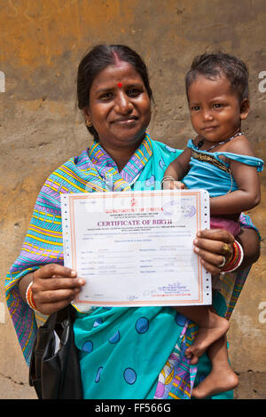 A mother and daughter in Cuttack, have just received her birth certificates from the Urban Law Centre run by the organisation CLAP. Committee for Legal Aid to Poor (CLAP), helps provide legal aid to the poorer communities in the Orissa district of India. Stock Photo