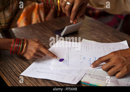 Signing the paper work. A woman from a rural slum in the Orissa district of India gets legal advice and birth certificates from a Legal Aid Clinic run by the organisation CLAP. Committee for Legal Aid to Poor (CLAP) is a non-profit organisation helping to provide legal aid to the poorer communities in the Orissa district of India. Stock Photo