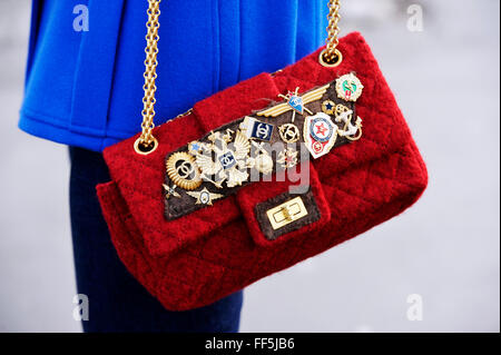 Black Chanel Bag with badges ans medals - Paris Fashion Week clutches and  bags Stock Photo - Alamy