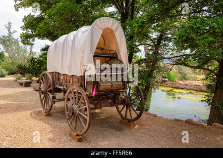 Nice old covered wagon in Arizona and lake in background Stock Photo