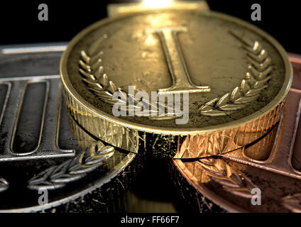 A closeup set of gold, silver and bronze medals on a dark background Stock Photo