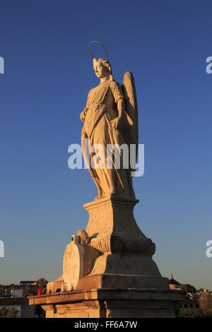 Angel San Rafael statue on Roman bridge with views cathedral, Cordoba ...